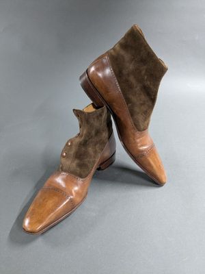 a pair of brown leather boots with brown sued soles