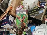 a cardboard box full of books and other items