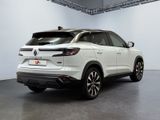 the rear end of a white suv parked in a garage