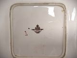 a white plate with a brown design on it