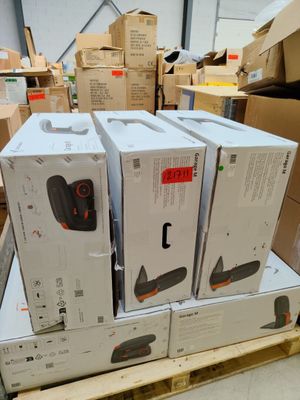 Plusieurs cartons contenant des appareils électroniques sont empilés sur des palettes dans un entrepôt.