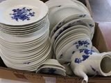 a lot of plates and cups in a box
