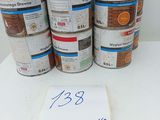 several cans of paint sitting on top of a table next to a sign