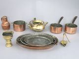 many different types of copper pots and pans on the table