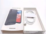 a box with a phone inside of it on a white surface