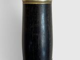 a black and gold vase with a bird on top of it