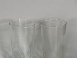 two glasses sitting next to each other on a table