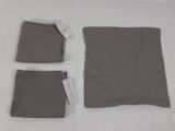 three pieces of clothing laid out on a white surface
