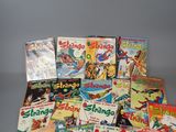 a lot of comic books sitting on a table