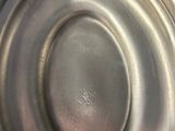 a close up of a metal object on a white surface