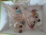 two glass figurines in a white box on a table