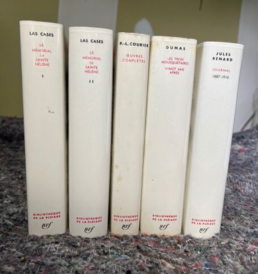 quatre livres sont alignés sur une table