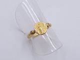 a close up of a gold ring with a coin on it