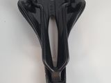 a close up of a bicycle seat on a white surface