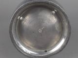 an image of a silver plate with a hole in the middle of it