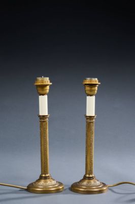 a pair of antique brass candles with white candlesticks