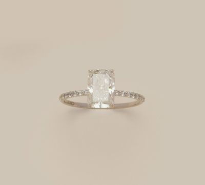 an engagement ring with a cushion cut diamond surrounded by diamonds
