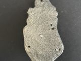 a close up of a metal object on a black surface
