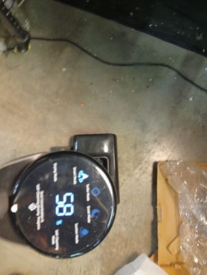 a clock that is sitting on the floor next to a box