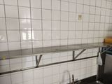 a stainless steel counter in a kitchen with a sink