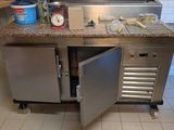 a stainless steel kitchen with a sink and a counter