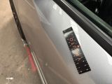 a sticker on the door of a car with a clock on it