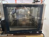 a small oven sitting on top of a wooden table