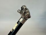 an image of a close up of a cane with a dog head on it