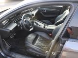 the interior of a car with the door open and the driver ' s seat down