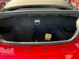 the trunk of a red car with a small block of cheese in it