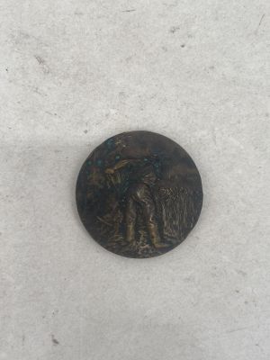 a small bronze coin with a man and a woman on it