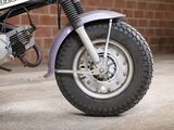 a motorcycle that is parked in front of a brick wall