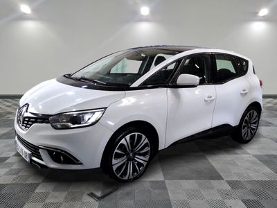 a white car is parked in a room with a checkered floor