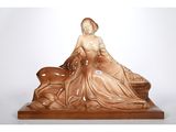 statue of a woman sitting on a bench with a dog in her lap