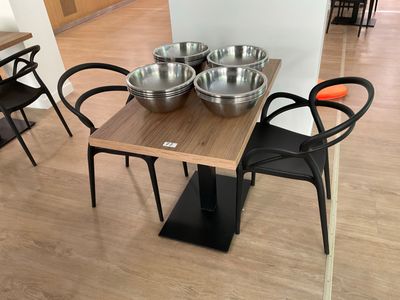 a table with four bowls on it and four chairs around it