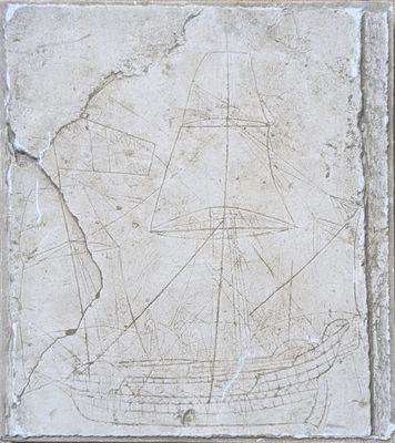 a stone plaque with a ship on it