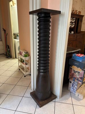 a tall wooden pole in the middle of a room