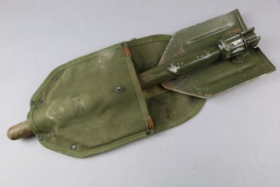 a small tool in a green pouch on a white surface