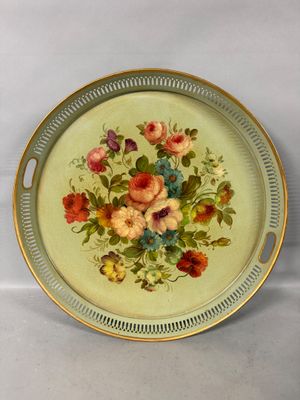 a plate with flowers painted on it on a table