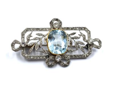 an image of a brooch with a blue topaz stone