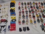 many different types of toy horses on the bed