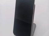 a cell phone that is sitting on top of a stand