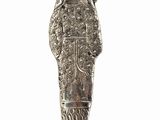 an old silver figurine of a woman with a veil on her head