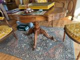 a table and chairs in a room with a rug on the floor
