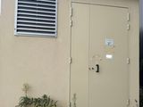 a small building that has a door and a window