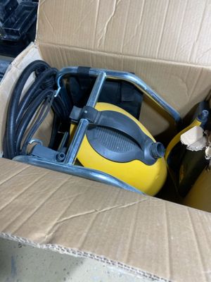 a box that has a yellow and black vacuum in it