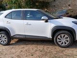 a white toyota rav parked in front of a stone building