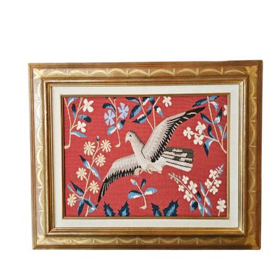 framed needled picture of a seagull in flight on a red background