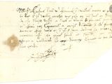un vieux morceau de papier sur lequel on a écrit, posé sur une table