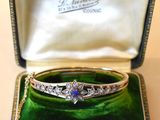 an image of a diamond and sapphire bangle in a box